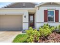 Inviting front entrance with lush landscaping and a decorative 'Welcome' sign at 1717 Hilltop Dr, Dundee, FL 33838