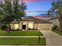 Charming single-Gathering home with lush front yard, a two-car garage, and inviting curb appeal at 1902 Tumblewater Blvd, Ocoee, FL 34761