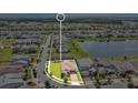 Aerial view of the property and the surrounding community, including a pond at 2009 Napoli Dr, St Cloud, FL 34771