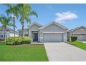 Charming single-story home with a well-manicured lawn and two palm trees in a quiet neighborhood at 2663 Youngford St, Orlando, FL 32824
