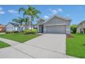 Well-maintained single-story home with lush landscaping and spacious driveway in a quiet community at 2663 Youngford St, Orlando, FL 32824