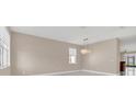 Bright living room featuring neutral walls, contemporary light fixture, and large windows at 2663 Youngford St, Orlando, FL 32824