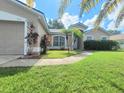 Well-maintained home featuring lush landscaping and a freshly mowed lawn at 283 Pine Arbor Dr, Orlando, FL 32825