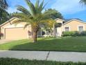 Charming single-Gathering home with a lush lawn and mature palm trees at 283 Pine Arbor Dr, Orlando, FL 32825