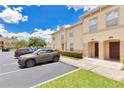 Well-maintained townhome complex, with ample parking and lush landscaping at 2855 Club Cortile Cir, Kissimmee, FL 34746