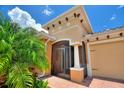 Inviting home exterior with a screened porch, decorative columns and brick pavers at 346 Treviso Dr, Kissimmee, FL 34759