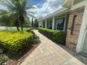 Single-story house with verdant landscaping and a brick walkway to the front door at 3715 Sarasota Ct, Orlando, FL 32812