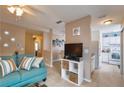 Open-concept living space with a comfortable sofa and view into kitchen at 4160 Pershing Pointe Pl # 1, Orlando, FL 32822