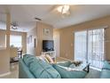 Open-concept living space with a comfortable sofa and sliding glass door at 4160 Pershing Pointe Pl # 1, Orlando, FL 32822