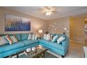 Cozy living room with a comfortable blue sofa and stylish decorative accents at 4160 Pershing Pointe Pl # 1, Orlando, FL 32822