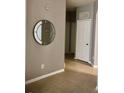 Entryway with tile floors, a stylish mirror on the wall, and a white door leading to another room at 6100 Stevenson Dr # 202, Orlando, FL 32835