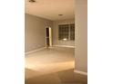 Neutral living room featuring tile floors, neutral-painted walls, and a large window for natural light at 6100 Stevenson Dr # 202, Orlando, FL 32835
