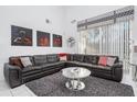 Spacious living room with a modern rug, stylish coffee table, and large sectional sofa at 7912 Golden Pond Cir, Kissimmee, FL 34747