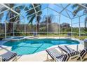 Inviting screened-in pool area with comfortable lounge chairs and serene backyard view at 7912 Golden Pond Cir, Kissimmee, FL 34747