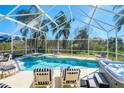Inviting screened-in pool area with comfortable lounge chairs and a relaxing hot tub at 7912 Golden Pond Cir, Kissimmee, FL 34747