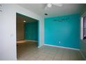 Bright room with tile flooring, light-colored walls, and teal accent wall with decorative lettering at 926 Chula Ct, Lady Lake, FL 32159