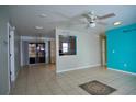 Bright living area features tile floors, ceiling fan, and access to kitchen and outdoor patio at 926 Chula Ct, Lady Lake, FL 32159