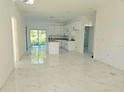 Bright, open-concept kitchen and living area features white cabinets, granite countertops and sliding glass doors at 1236 N Virginia Ave, Lakeland, FL 33805