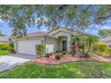 Charming single-story home with a two-car garage, landscaped yard, and inviting curb appeal at 14287 E Weymouth Run, Orlando, FL 32828