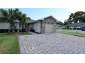 Beautiful one-story home with desert landscaping, brick paver driveway, and a two-car garage at 1749 Christina Lee Ln, St Cloud, FL 34769