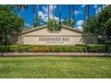 Kissimmee Bay Country Club sign with colorful flowers and lush greenery at 1810 Lee Janzen Dr, Kissimmee, FL 34744