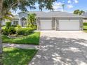Charming home featuring a well-manicured lawn, stone accents and a three car garage at 1810 Lee Janzen Dr, Kissimmee, FL 34744
