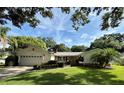 Charming one-story home featuring lush landscaping and a well-manicured lawn at 1921 Japonica Rd, Winter Park, FL 32792