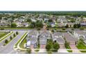 An aerial view shows the neighborhood with manicured lawns and well-maintained houses at 2740 Picasso Ct, Kissimmee, FL 34743