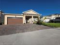 Inviting single-story home with a stone-accented facade, well-manicured landscaping, and a paved driveway at 2853 Willowseed Ln, St Cloud, FL 34772