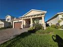 Beautiful single-Gathering home with a two-car garage, a covered front porch, and lush green lawn at 2853 Willowseed Ln, St Cloud, FL 34772