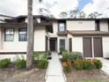 Inviting townhome showcases lush landscaping and a well-lit walkway at 3006 S Semoran Blvd # H-3, Orlando, FL 32822