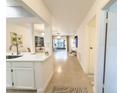 Bright living space with tile flooring, leading to an open kitchen and sunlit patio at 3006 S Semoran Blvd # H-3, Orlando, FL 32822