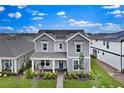 Inviting two-story home showcasing a manicured front yard and a cozy front porch at 3026 Prospect Trl, St Cloud, FL 34771