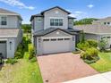Charming two-story home with brick driveway and green front lawn creates instant curb appeal at 3204 Oxbow Ct, St Cloud, FL 34773