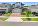 Charming two-story home with brick driveway and well-manicured front lawn creates great curb appeal at 3204 Oxbow Ct, St Cloud, FL 34773