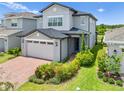 Charming two-story home features brick driveway and well-manicured front yard at 3204 Oxbow Ct, St Cloud, FL 34773