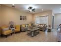 Comfortable living room with tile flooring, ceiling fan, and neutral color palette, perfect for relaxing at 406 Cinnamon Dr, Kissimmee, FL 34759