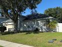 Inviting single-story home with a manicured lawn, attached garage, and mature landscaping offering shade at 478 Acacia Tree Way, Kissimmee, FL 34758
