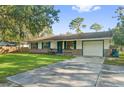 Inviting single-story home with brick accents, a well-kept lawn, and a convenient attached garage at 4805 Jay Dr, St Cloud, FL 34772