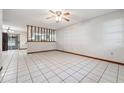 Spacious living room with tile floors, a ceiling fan, and a bright, open layout at 4805 Jay Dr, St Cloud, FL 34772