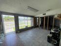 Spacious commercial interior with large windows, tile flooring, and visible wall framing, offering renovation potential at 4950 Silver Star Rd, Orlando, FL 32808