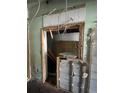 Renovation view showing door frame and wall with exposed building materials, needing structural updates at 4950 Silver Star Rd, Orlando, FL 32808