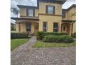 Charming two-story townhouse featuring a well-maintained front yard with lush landscaping and inviting entryway at 746 Terra Lago St, Davenport, FL 33897