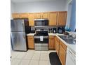 Efficient kitchen with stainless steel appliances, plentiful cabinetry, and tile flooring at 746 Terra Lago St, Davenport, FL 33897
