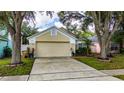 Inviting one story home featuring manicured lawn, mature trees, and charming curb appeal at 10934 Rushwood Way, Clermont, FL 34714