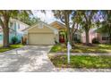 Inviting one story home featuring manicured lawn, mature trees, and charming curb appeal at 10934 Rushwood Way, Clermont, FL 34714