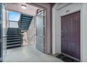 Hallway featuring stairs to the upper floors, and the front door to unit 201 at 1351 Venezia Ct # 201, Davenport, FL 33896
