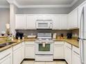 Bright kitchen featuring appliances, neutral countertops, and white cabinets at 1361 Tuscan Ter # 7303, Davenport, FL 33896