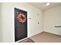 Welcoming entrance with decorative wreath on dark door, creating a warm and inviting first impression at 193 Longview Ave # 203, Celebration, FL 34747
