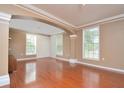 Open living room with hardwood floors, archway and neutral paint, creating an inviting space at 193 Longview Ave # 203, Celebration, FL 34747